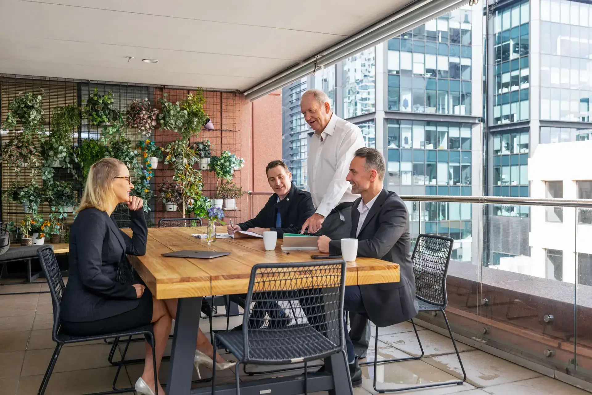 Modern coworking office with spacious workstations, large windows letting in natural light, and stylish furnishings, creating a welcoming and productive atmosphere